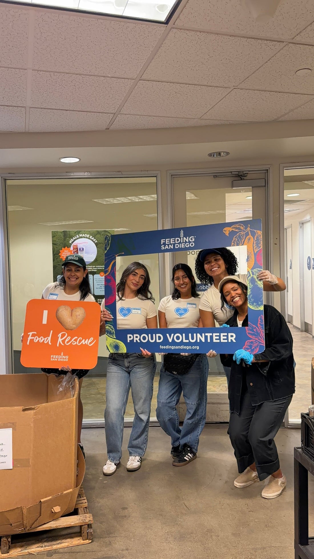 happy girl club volunteers at feeding san diego warehouse